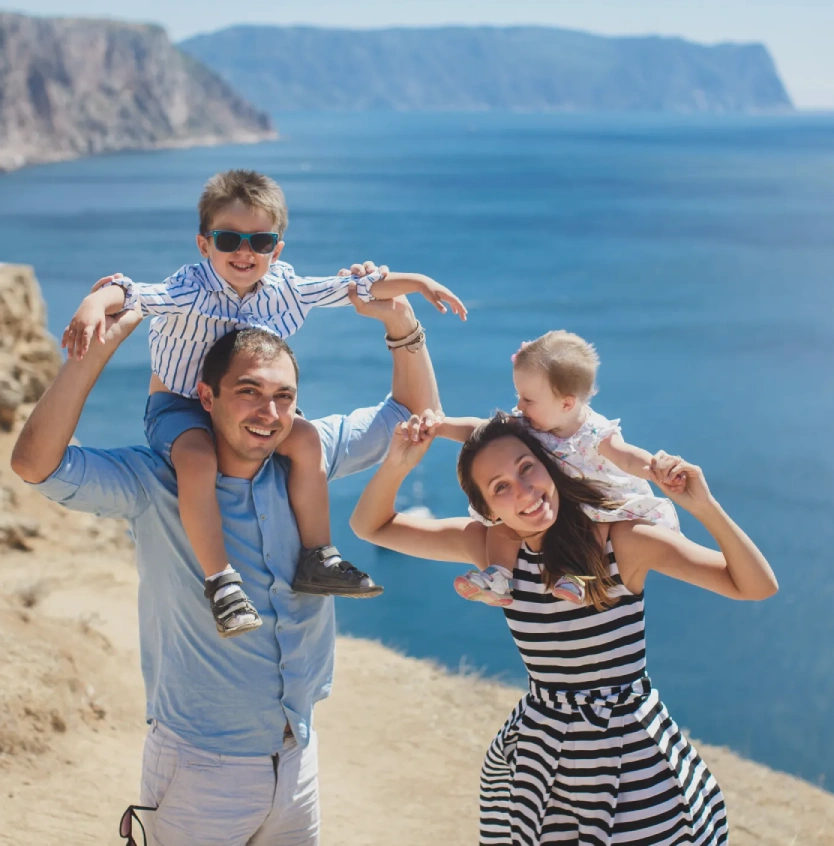 Portrait of happy family in the mountains beach